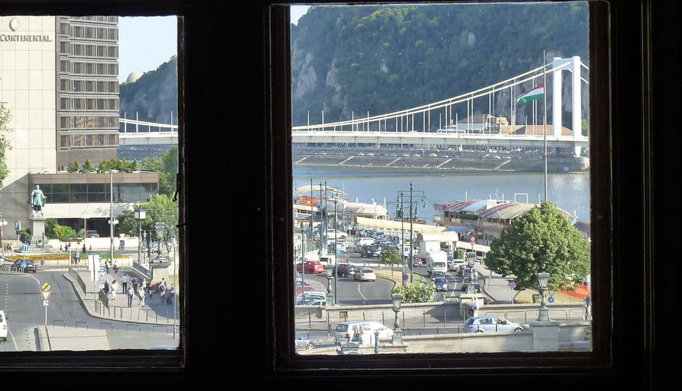 Budapest bridge and Hungarian flag viewed through a window