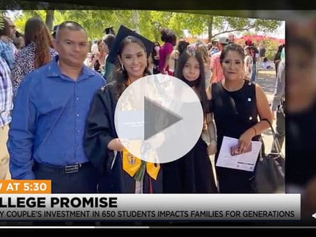 Proud parents standing with their college graduate.